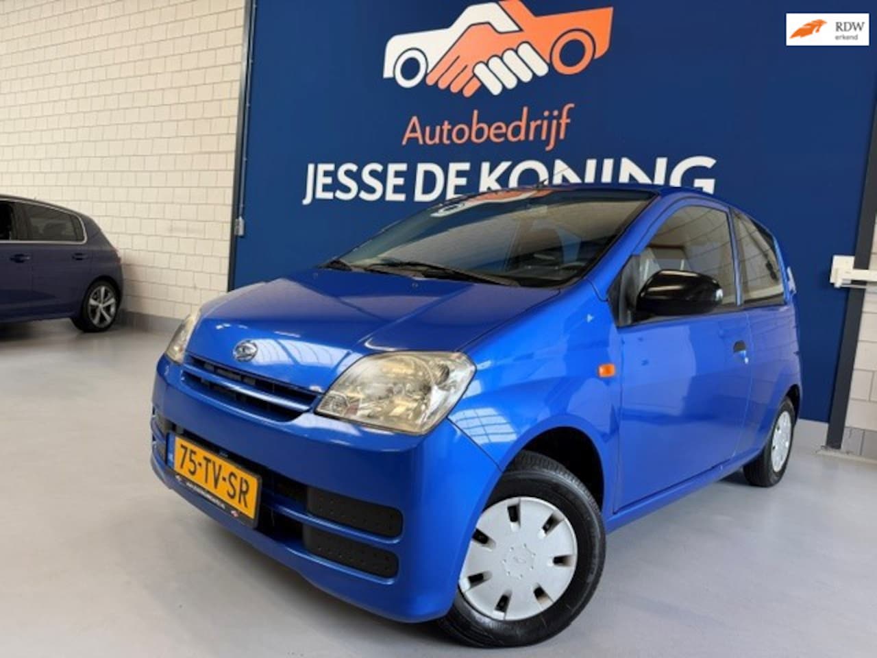 Daihatsu Cuore - 1.0-12V Tokyo / bj.2007 / kleur: blauw / NAP met 102077 km.en APK tot 06/2027 / stuurbekra - AutoWereld.nl
