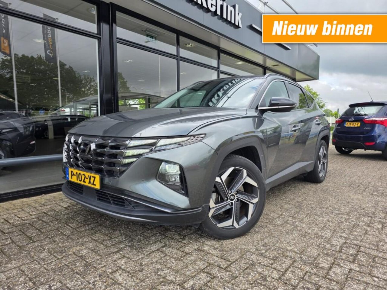 Hyundai Tucson - 1.6 T-GDI HEV Comfort Smart Adaptive/elektr.a.klep/19 velgen/trekhaak/ two-tone - AutoWereld.nl