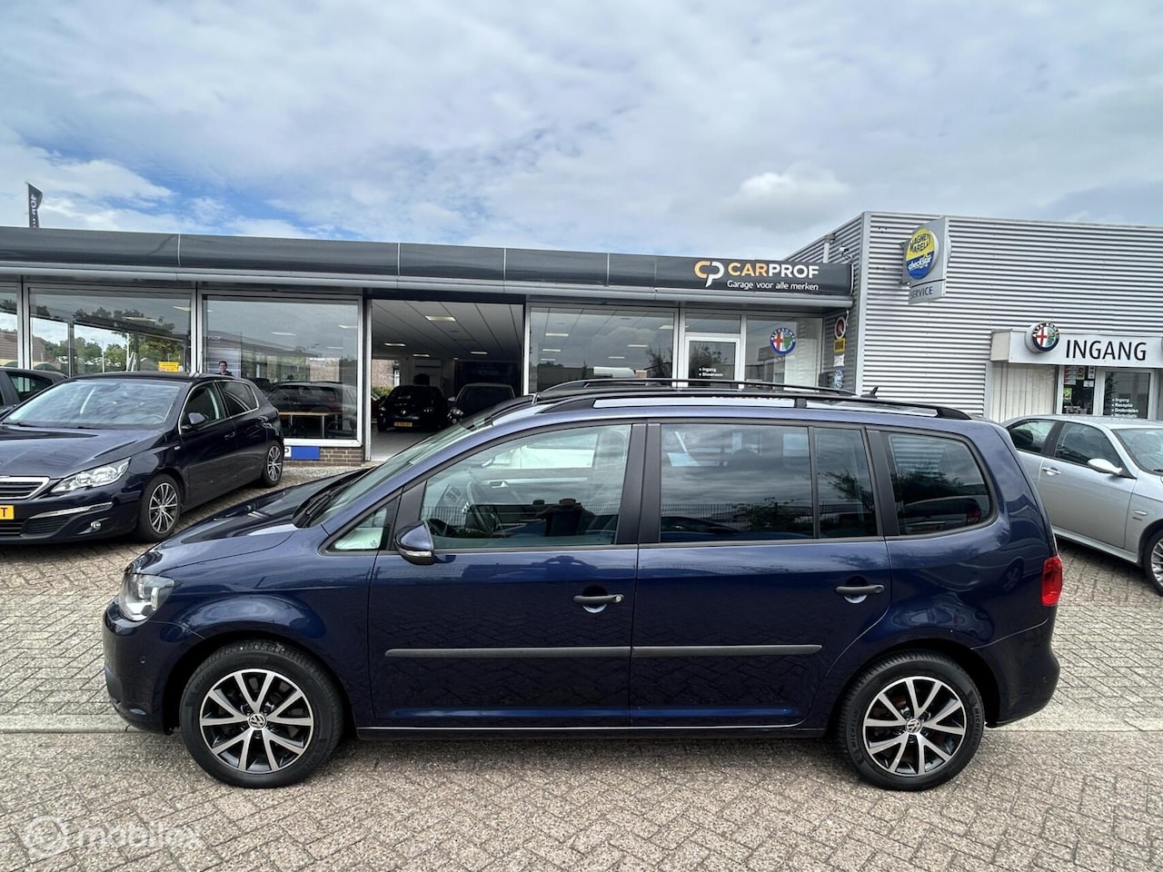 Volkswagen Touran - 1.4 TSI Highl. 7p. Automaat Pano - AutoWereld.nl