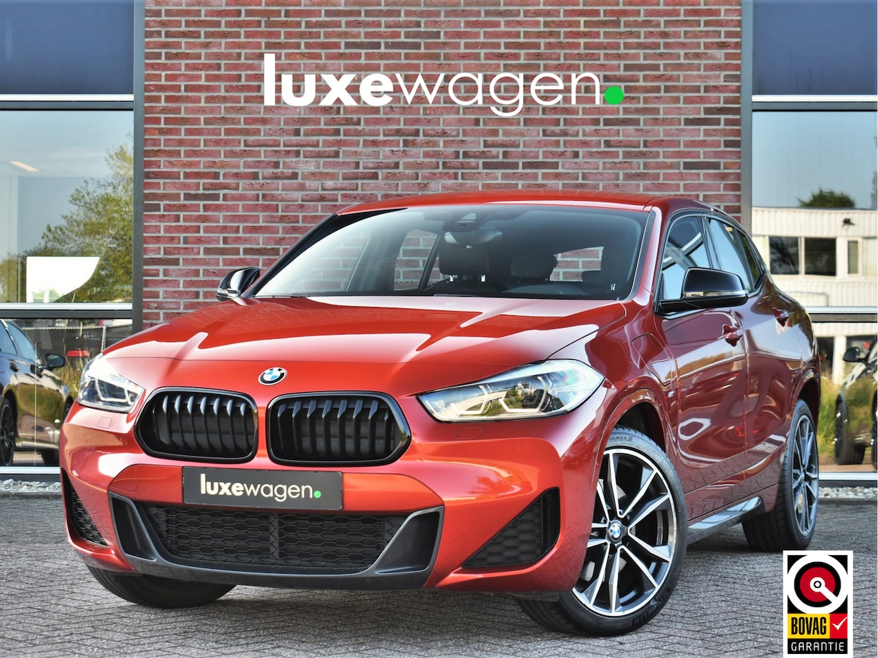 BMW X2 - xDrive25e M-Sport Sunset Orange | ACC | Leder | Elek-klep - AutoWereld.nl