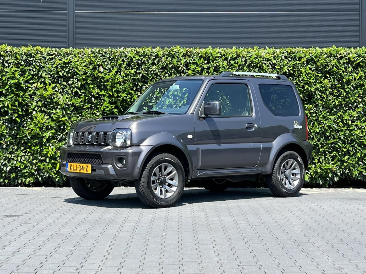 Suzuki Jimny - 1.3 Exclusive RANGER, LEDER, AIRCO, STOELVERWARMING, TREKHAAK, LICHTMETAAL 15" - AutoWereld.nl