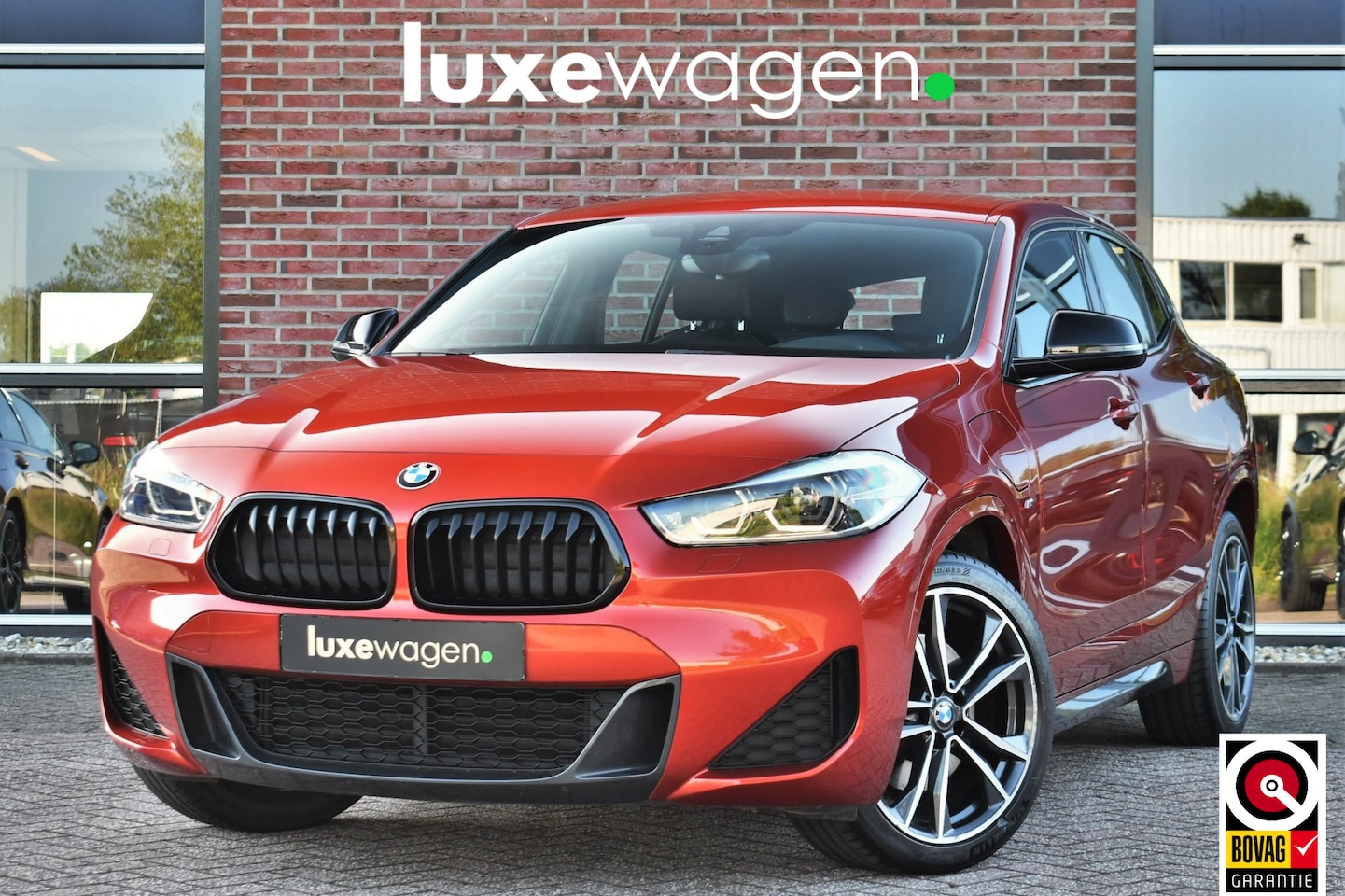 BMW X2 - xDrive25e M-Sport Sunset Orange | ACC | Leder | Elek-klep - AutoWereld.nl