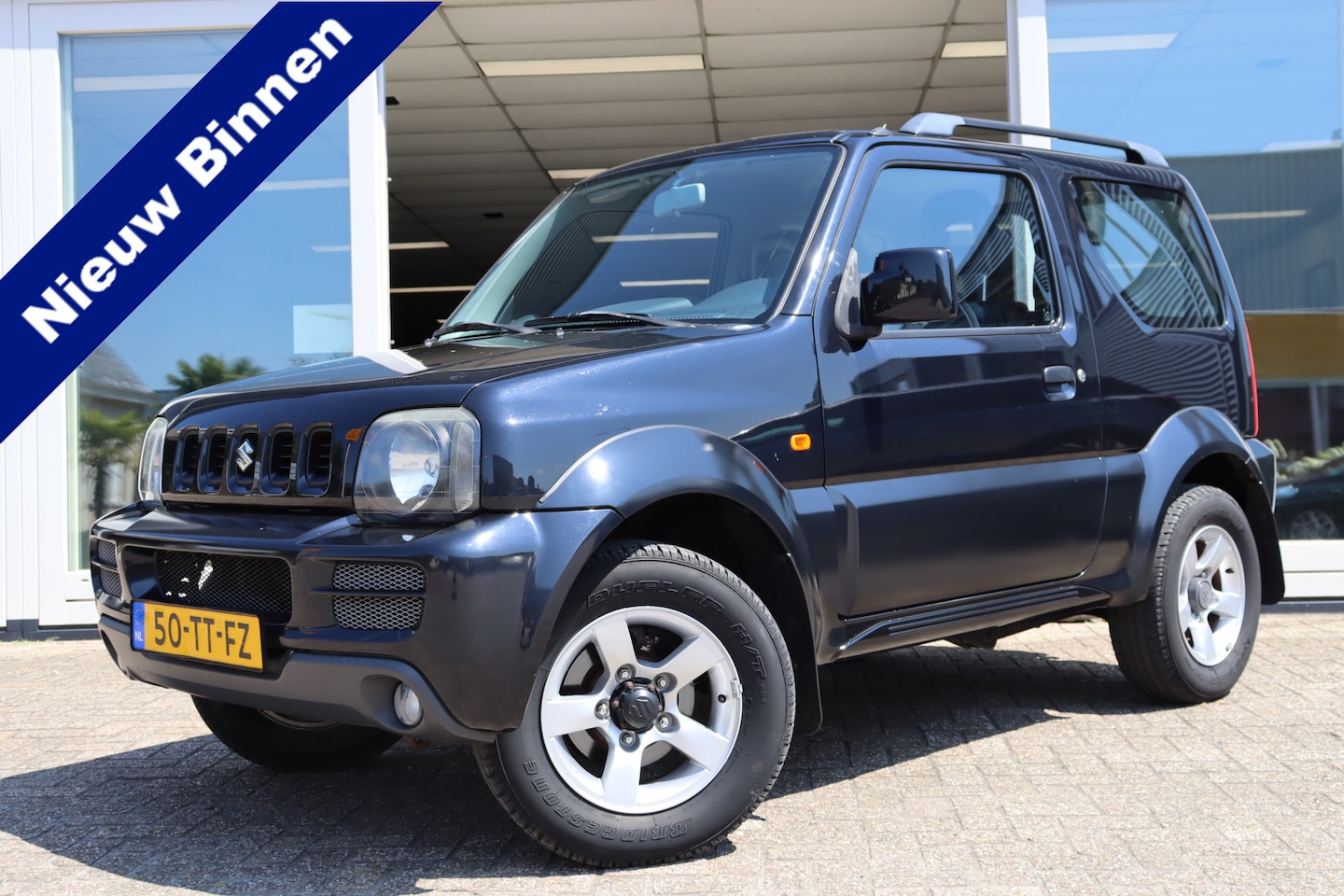 Suzuki Jimny - 1.3 Exclusive 1.3 Exclusive, Airco, Trekhaak, Elek. ramen, NAP, Prijs is Rijklaar Inclusief 6 Maanden Ga - AutoWereld.nl