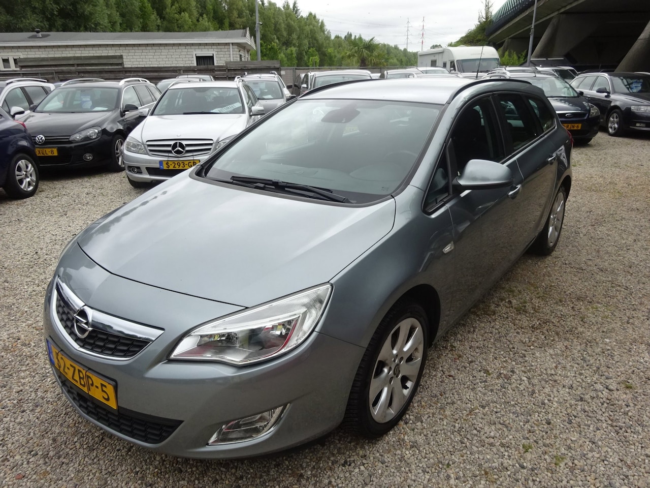 Opel Astra Sports Tourer - 1.4 Cosmo airco cruise control trekhaak - AutoWereld.nl