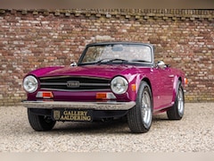 Triumph TR6 - Overdrive "In Magenta" "In Magenta" - AI says": psychedelic purple-pink that stands out fr