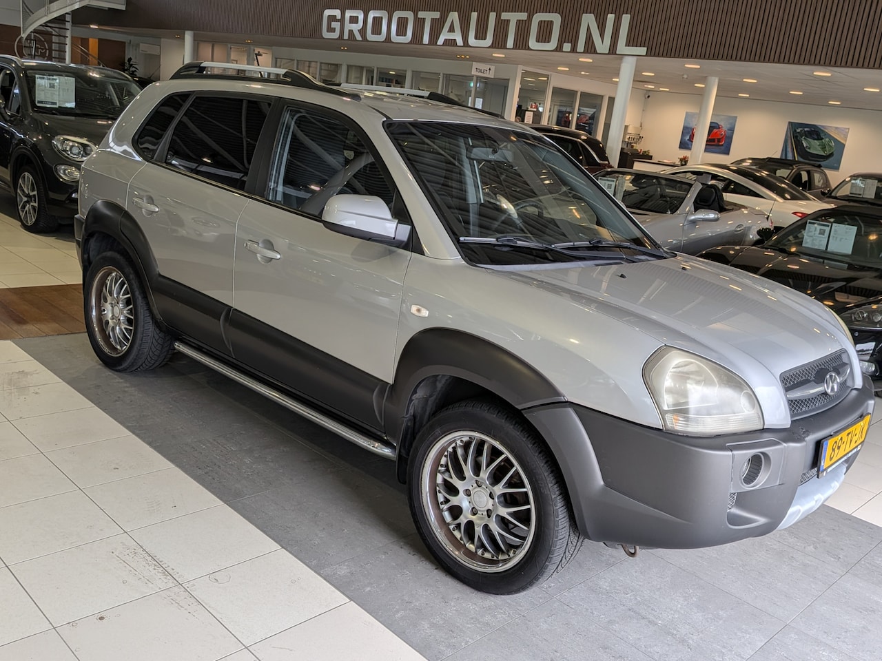Hyundai Tucson - 2.0i Dynamic Cross Airco, Cruise Control, Trekhaak, Stuurbekrachtiging - AutoWereld.nl