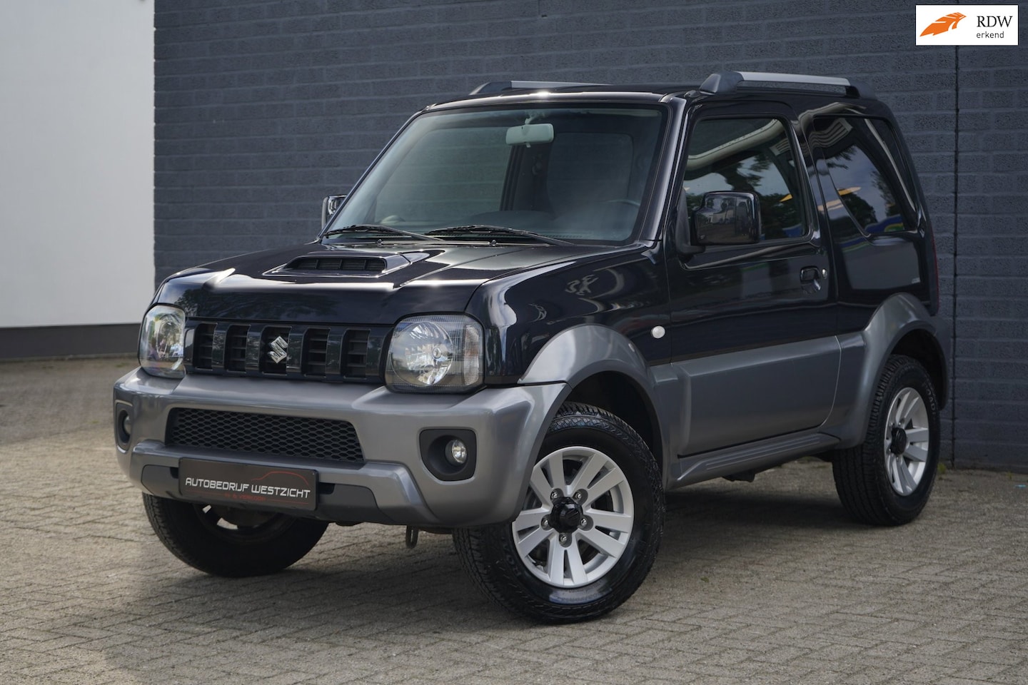 Suzuki Jimny - 1.3 Exclusive 4WD, Leer, Airco, Stoelverwarming - AutoWereld.nl