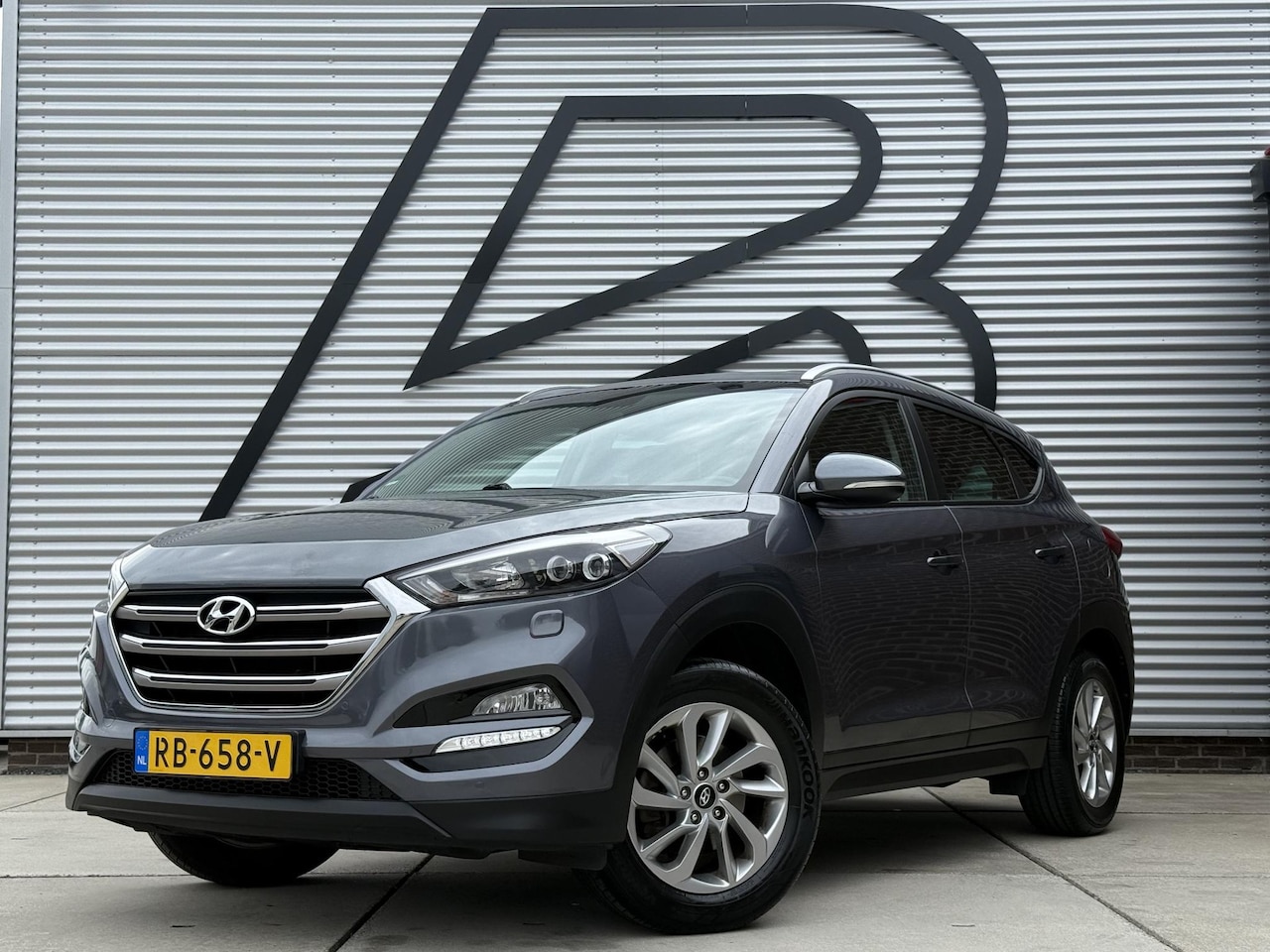 Hyundai Tucson - 1.6 GDi Comfort 1e Eigenaar|Navi|Camera|Clima|Stoelverwarming|Cruise|Trekhaak|Leder|6-bak| - AutoWereld.nl