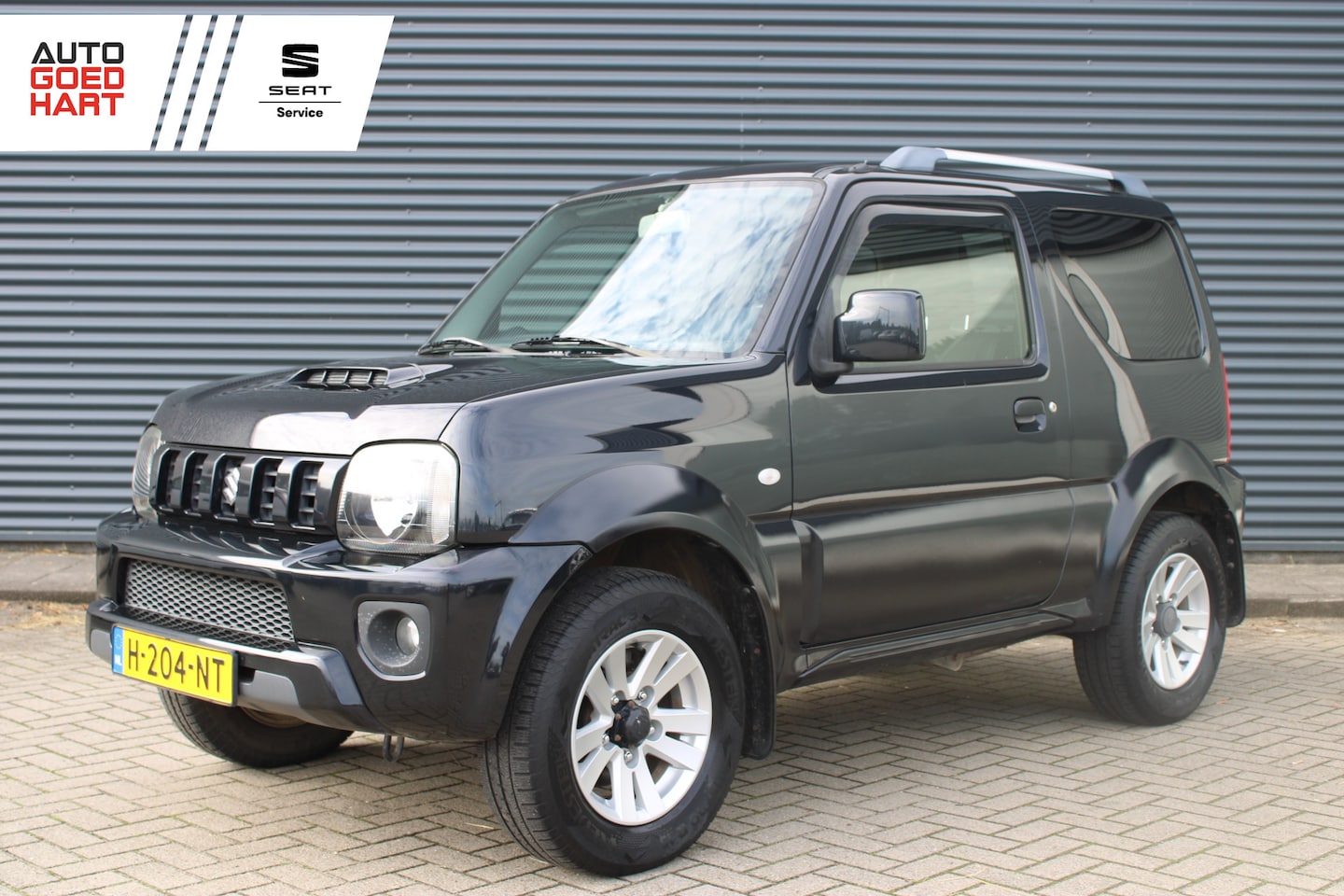 Suzuki Jimny - 1.3 Exclusive 4x4 Vol-Leder Stoelverwarming Airco Trekhaak - AutoWereld.nl