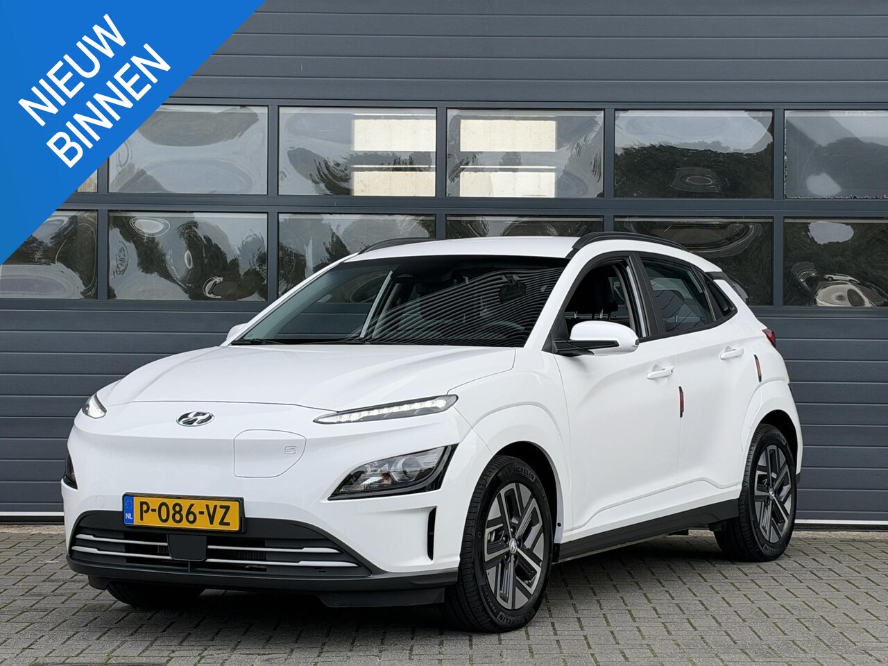 Hyundai Kona Electric - EV COMFORT 64 kWh (99% SOH) I AUTOMAAT I TREKHAAK I APPLE CARPLAY I P-CAMERA - AutoWereld.nl