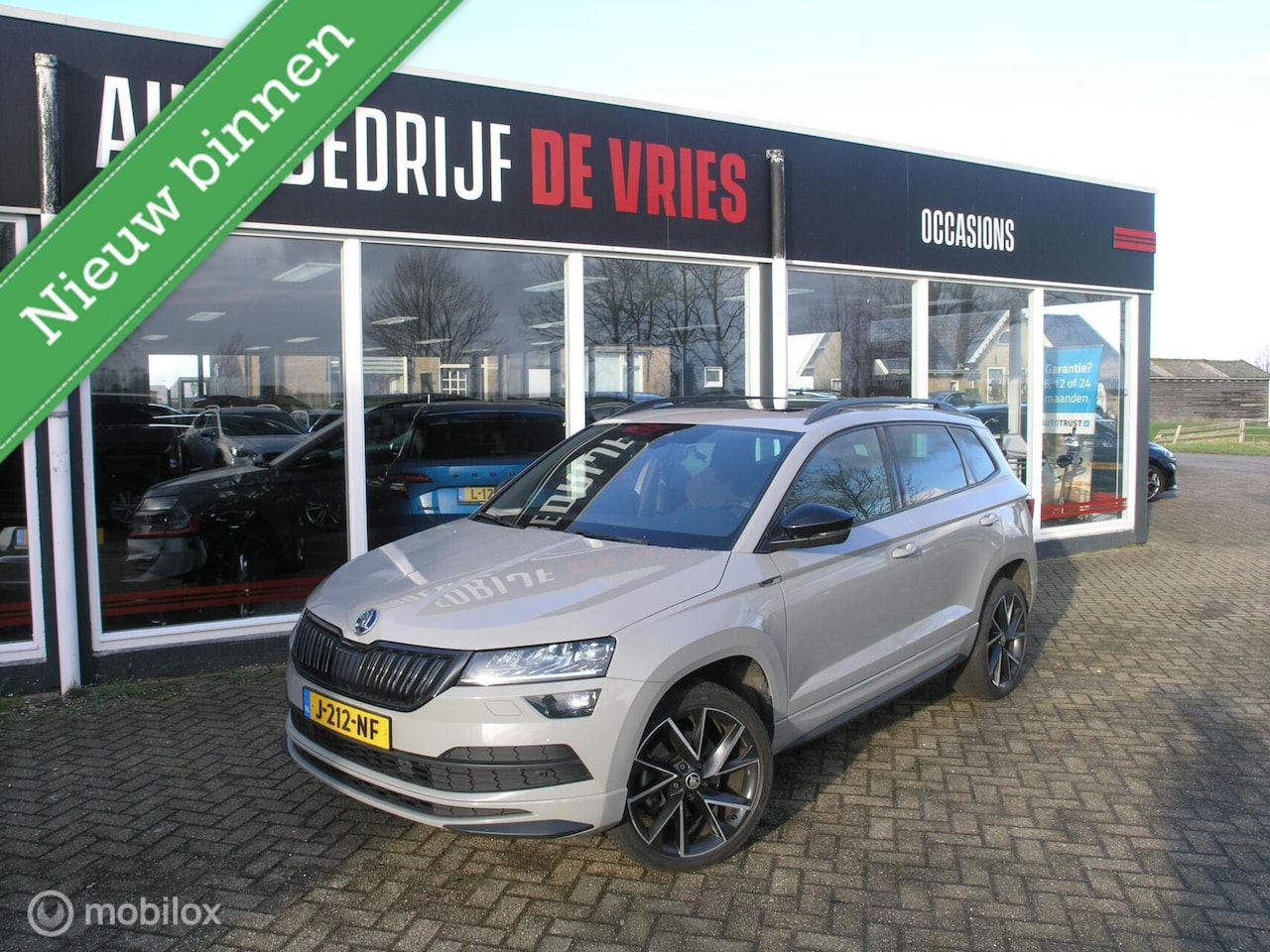 Skoda Karoq - 1.5 TSI ACT Sportline Bsns Pano/Canton/ACC/Trekhaak - AutoWereld.nl