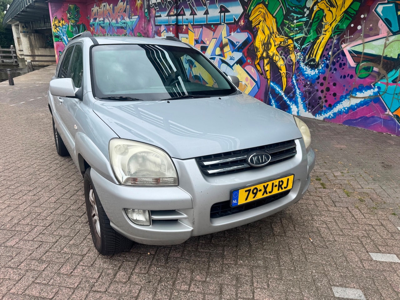 Kia Sportage - 2.0 CVVT X-pression leer airco elektrische ramen sport velgen apk verlopen zo mee export p - AutoWereld.nl
