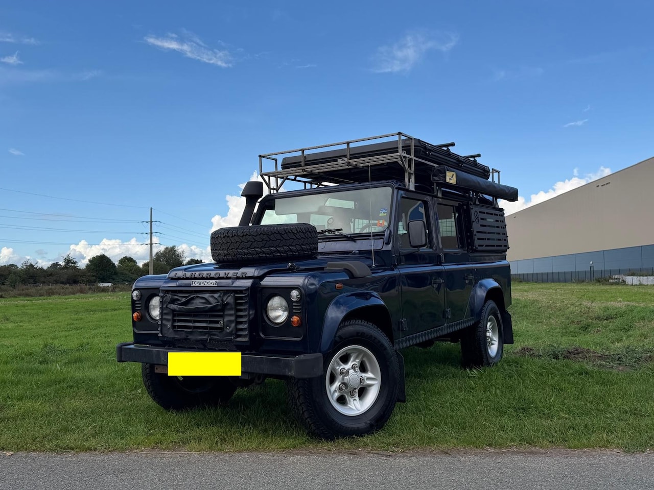 Land Rover Defender 110 - 2.5 TD5 |AIRCO|9-PERS|DAKTENT|LUIFEL|GEEL KENT - AutoWereld.nl